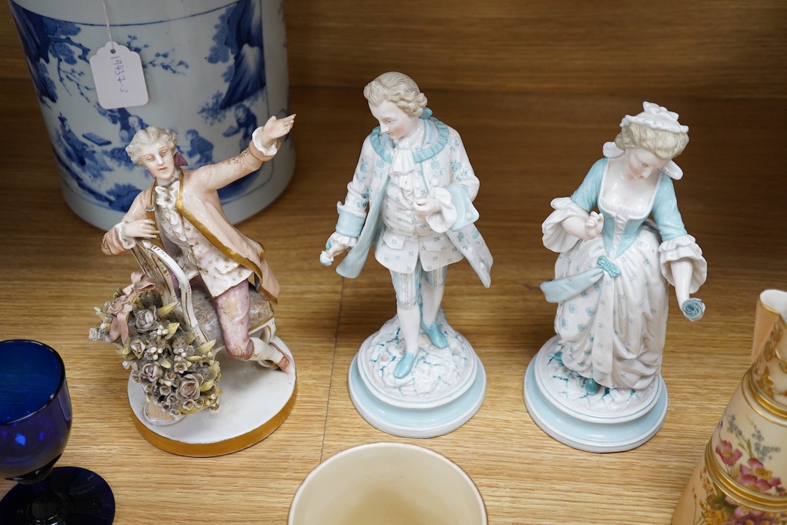Sundry porcelain comprising three German figures, a Royal Worcester blush ivory ewer and a mug, together with a blue wine glass, largest 26cm high